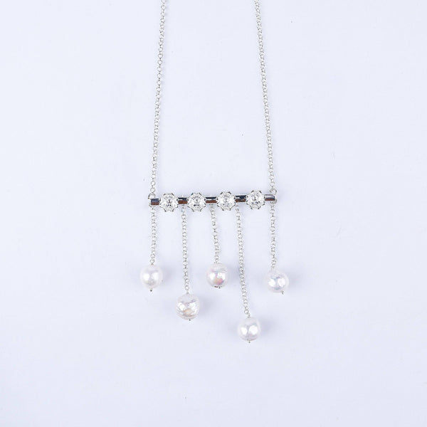 Close-up of silver flower pearl necklace chain