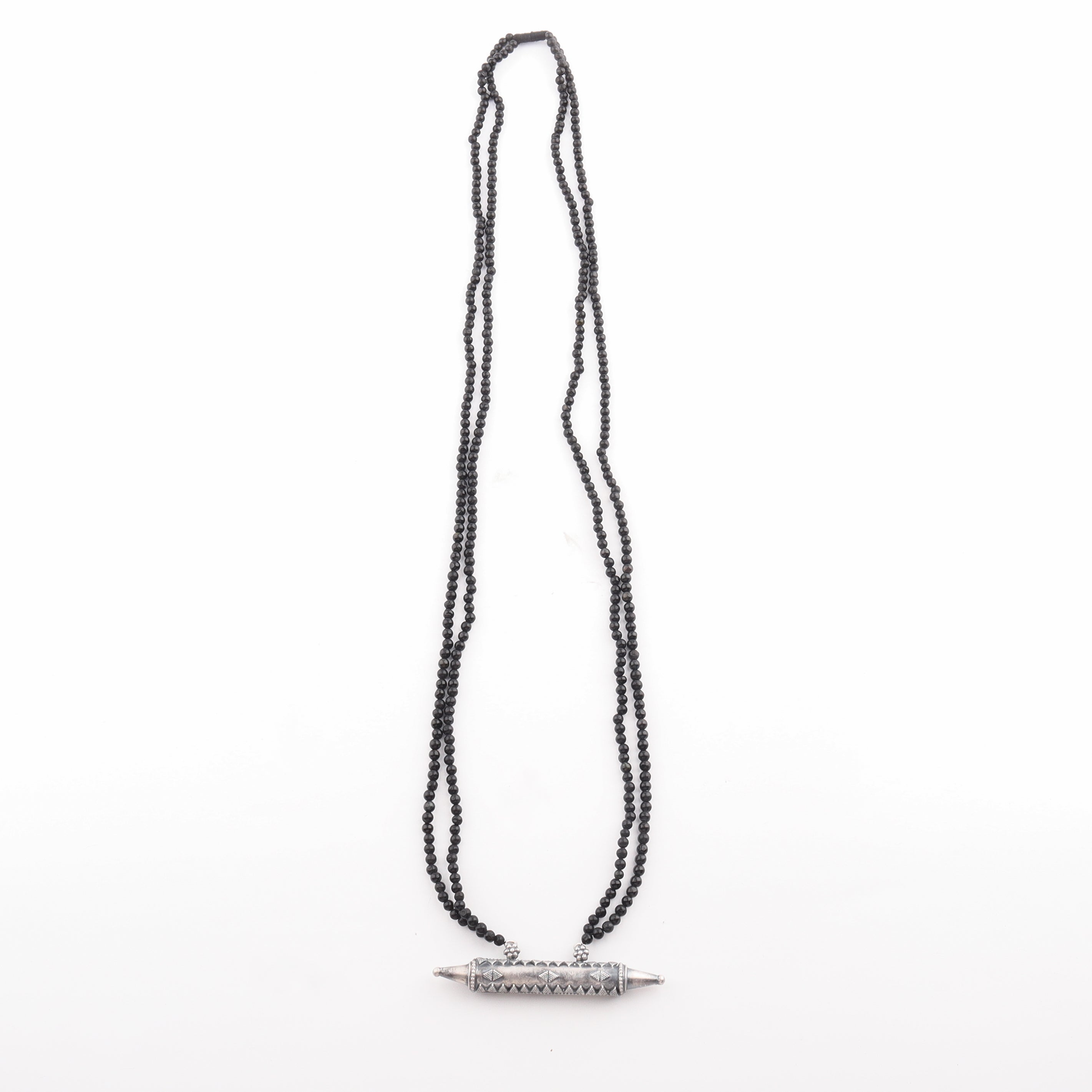 Close-up of black tourmaline necklace with silver pendant