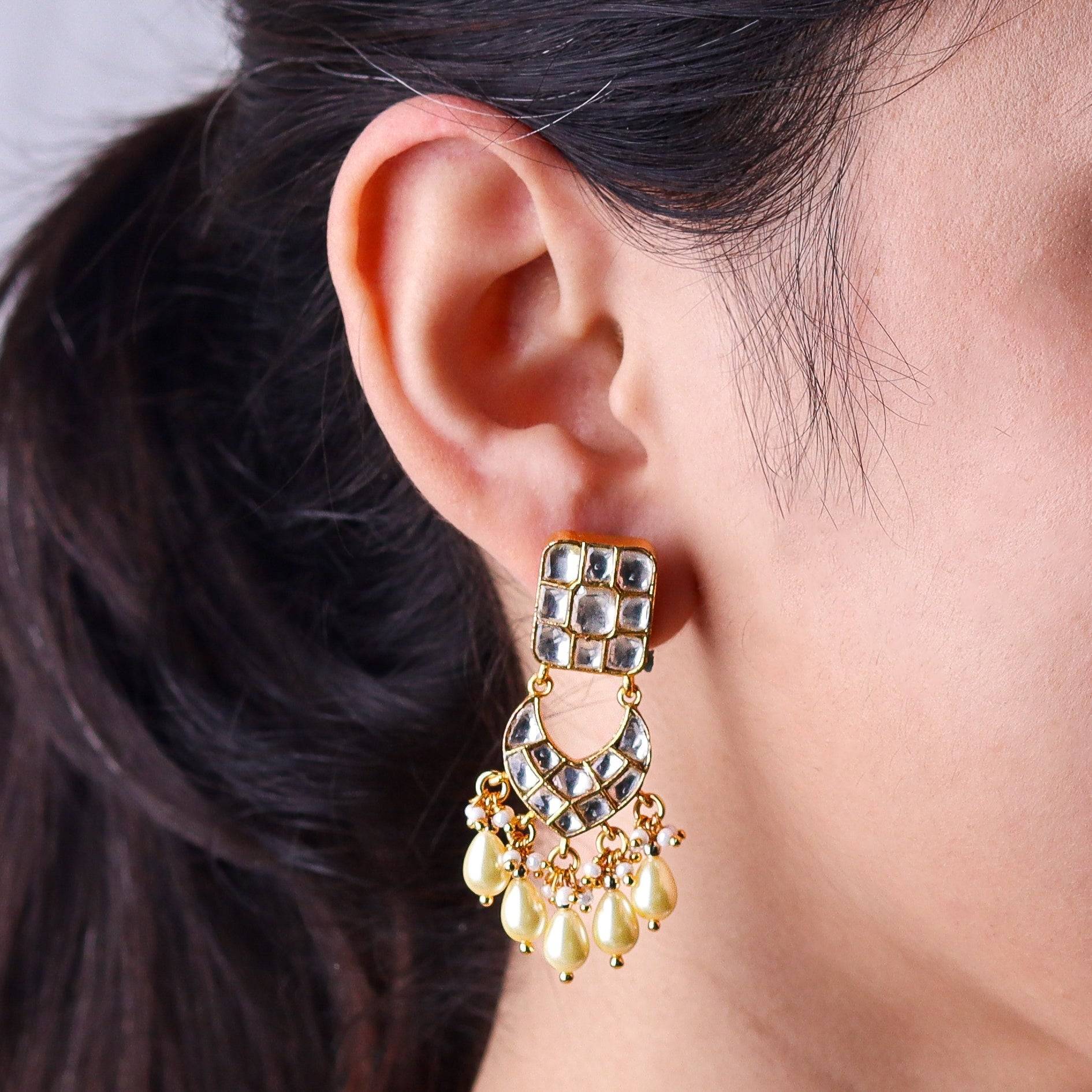 Model wearing a 22K gold-plated fashion earring for a sophisticated and contemporary jewelry look
