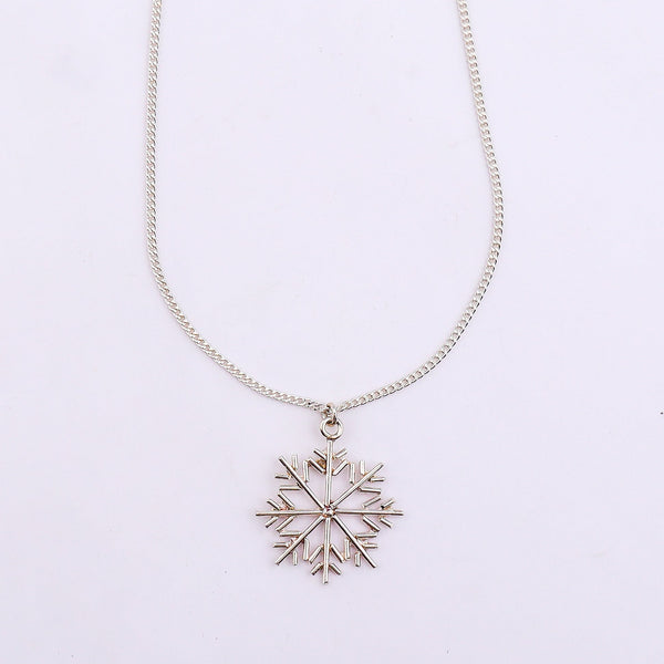Silver snowflake pendant necklace on white background