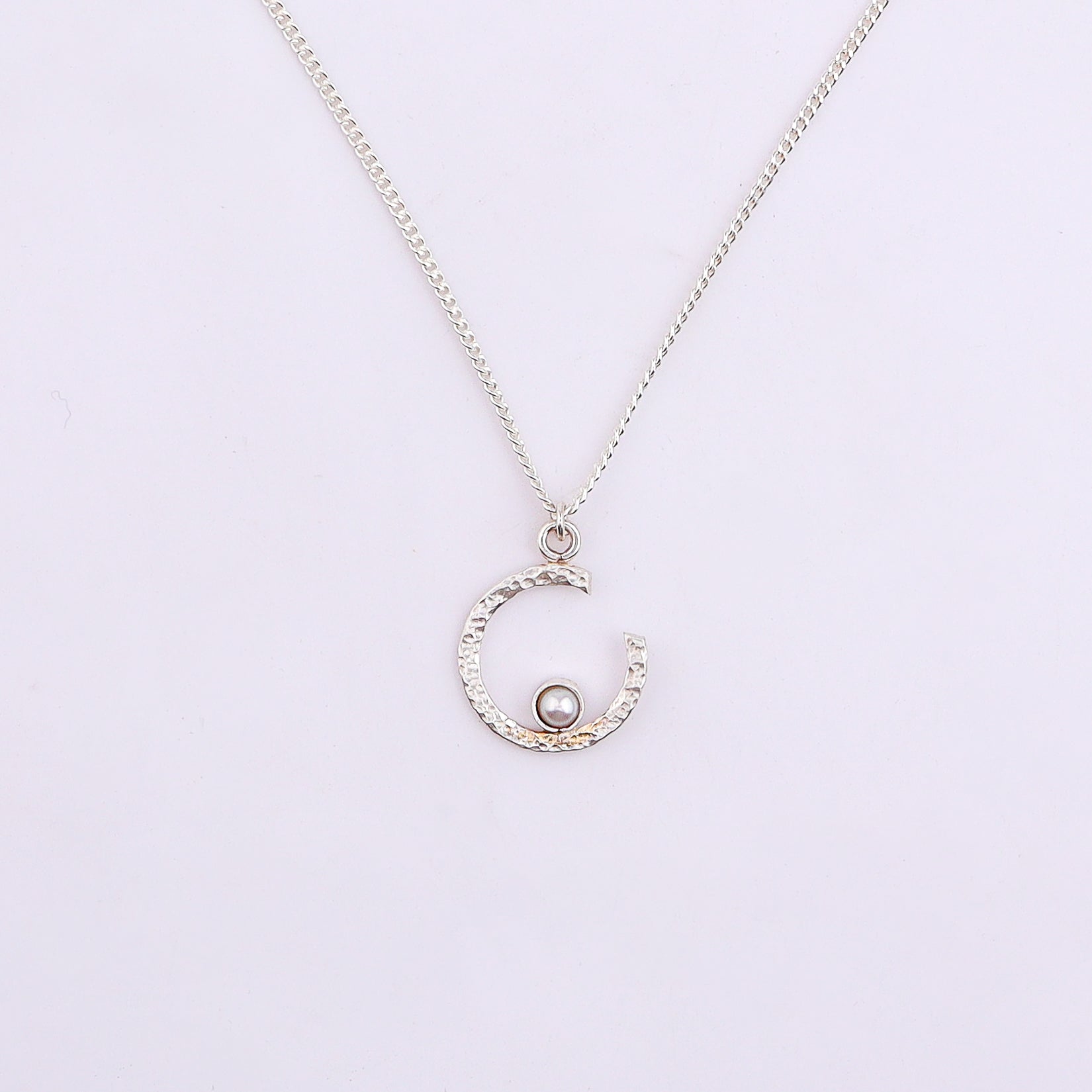 Silver semi-circle pearl necklace with modern design