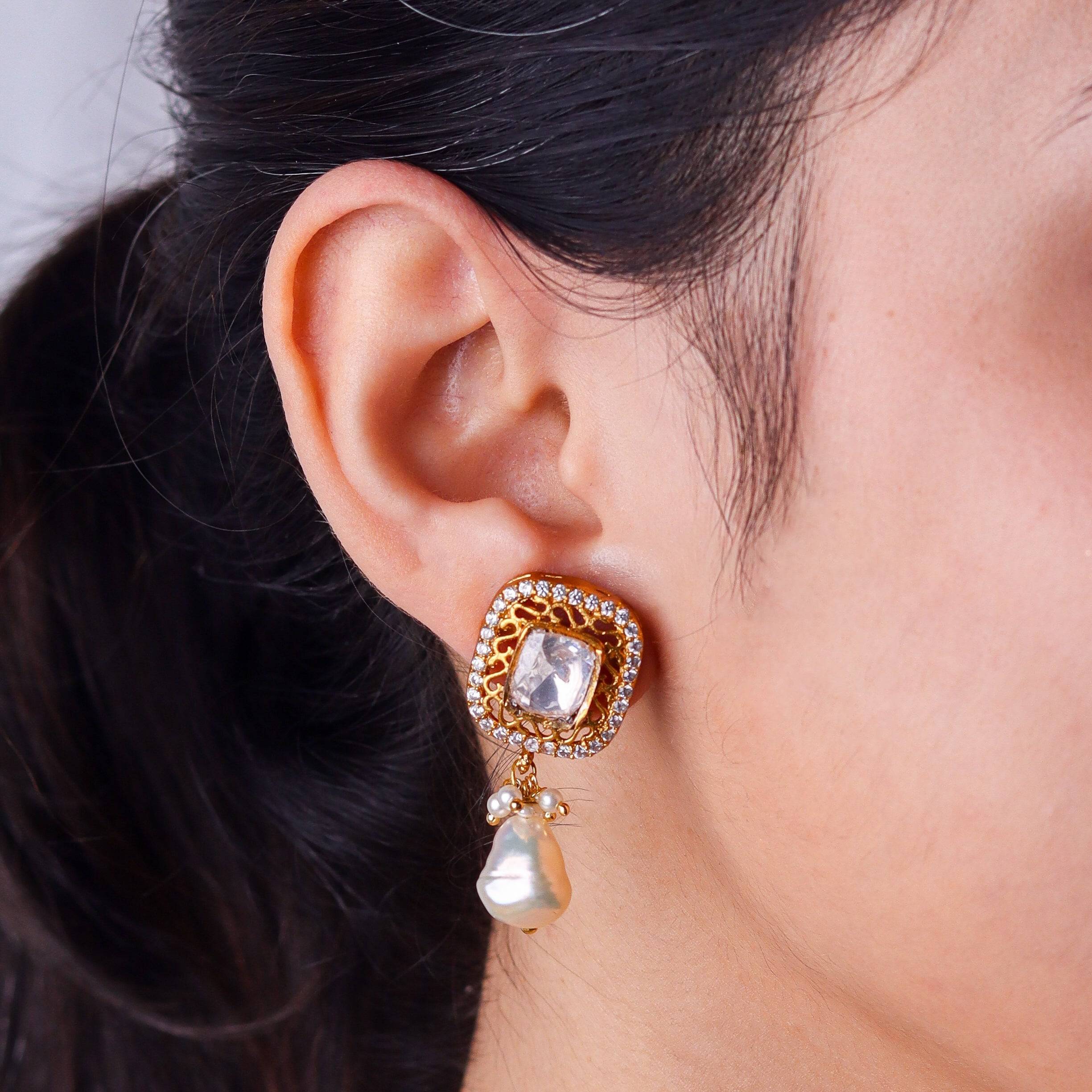 Model wearing a 22K gold-plated fashion earring for a sophisticated and contemporary jewelry look