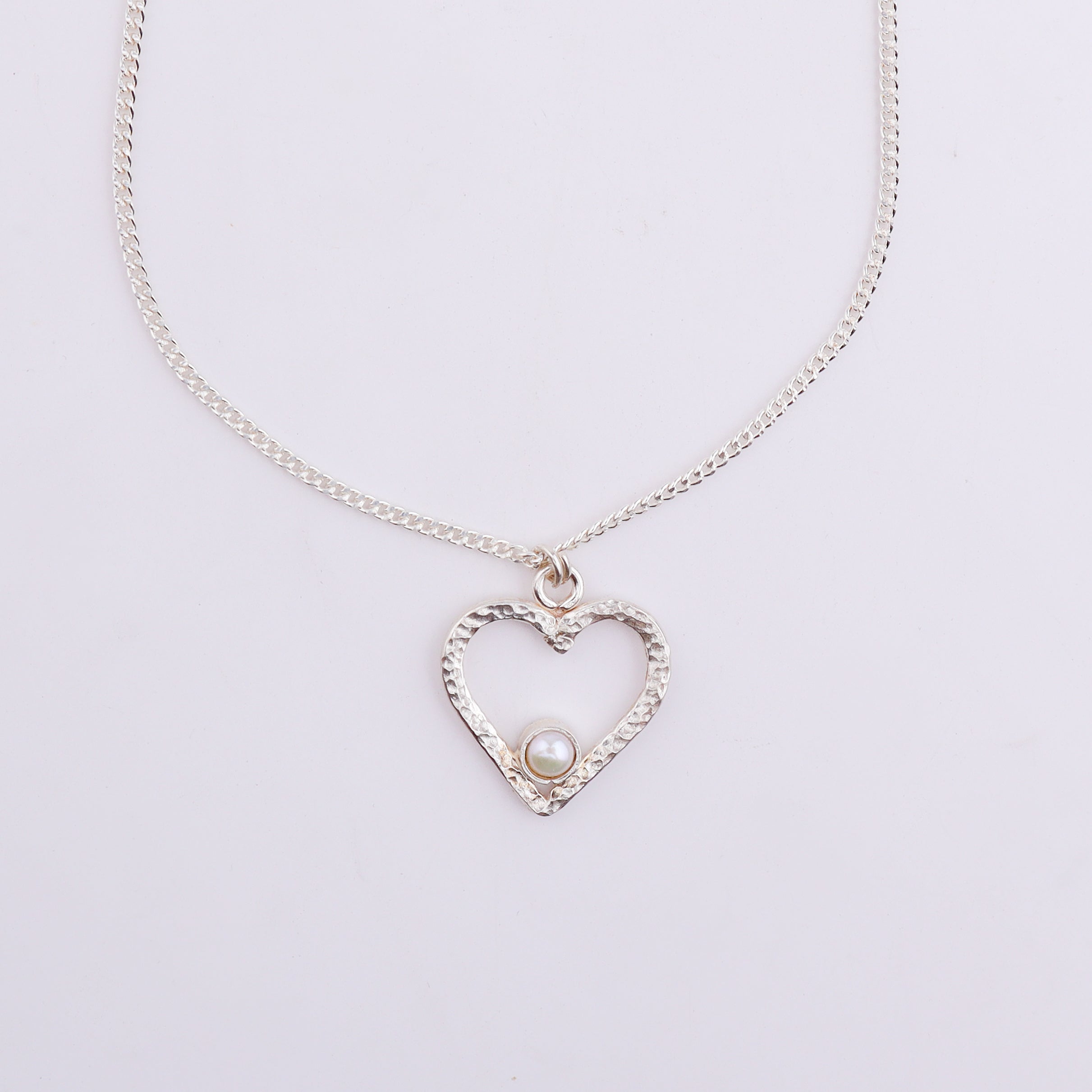 Close-up of silver heart pendant necklace