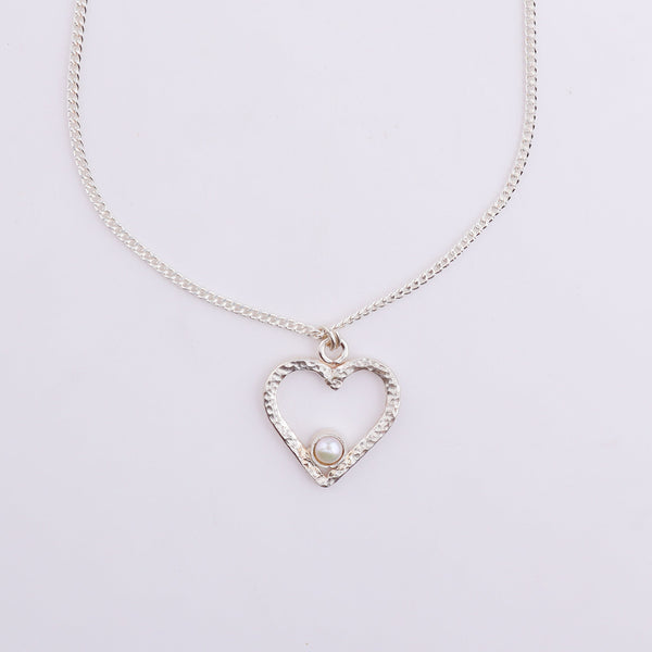 Close-up of silver heart pendant necklace