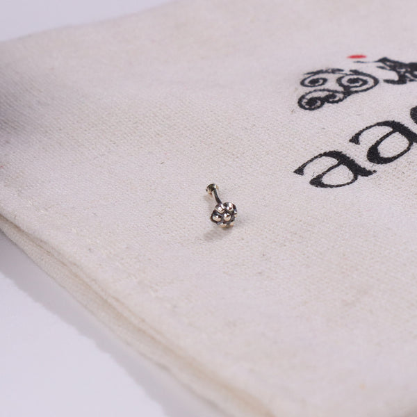 Close-up of silver nose pin on white background