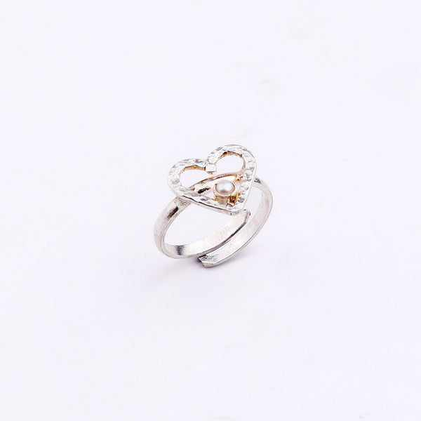 Silver heart pearl ring on white background