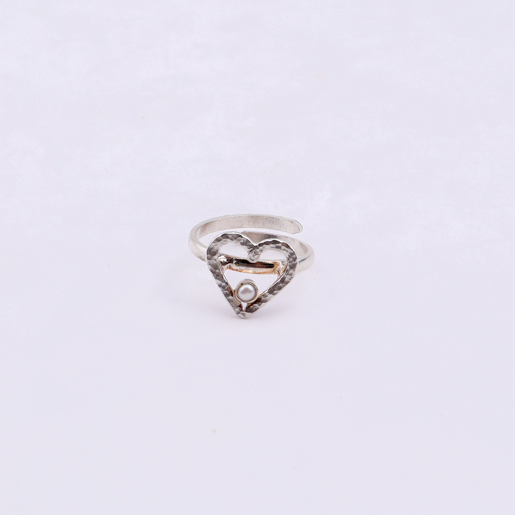 Silver heart pearl ring with open design