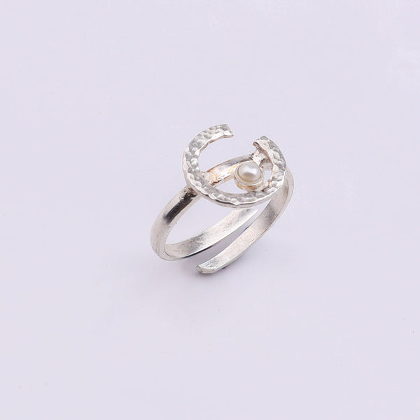 Silver ring with textured semi-circle design and pearl accent