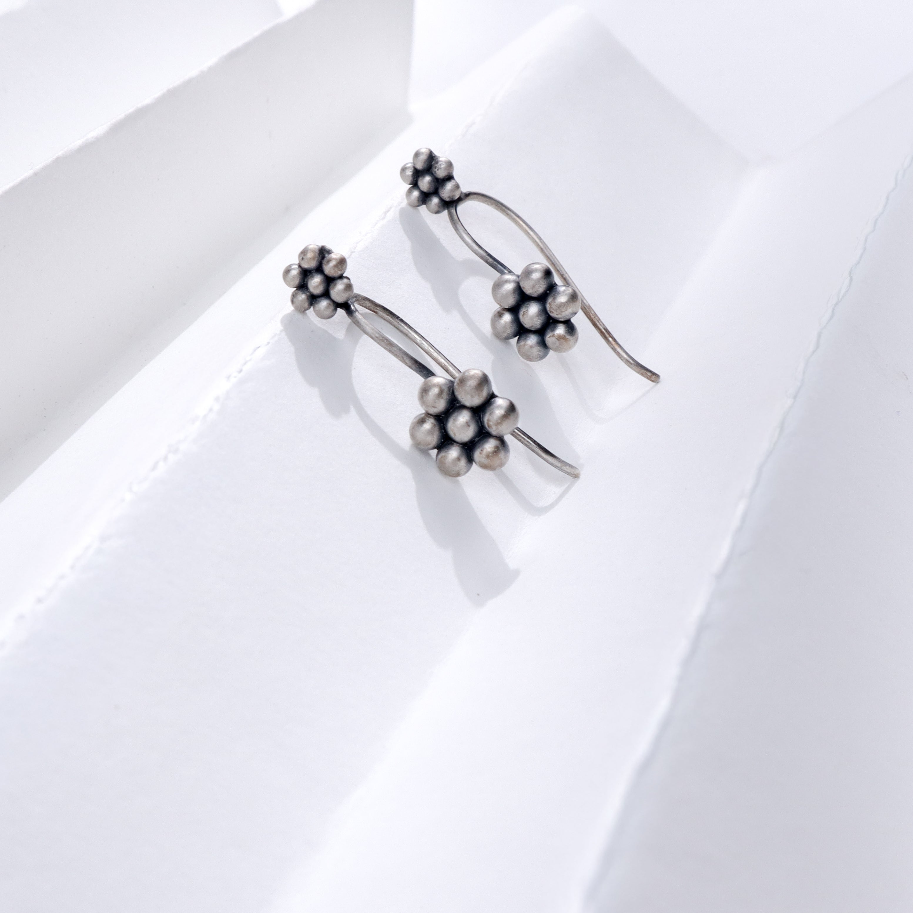 Silver Kudi Bugadi earrings with floral design, handcrafted sterling silver jewelry for festive occasions