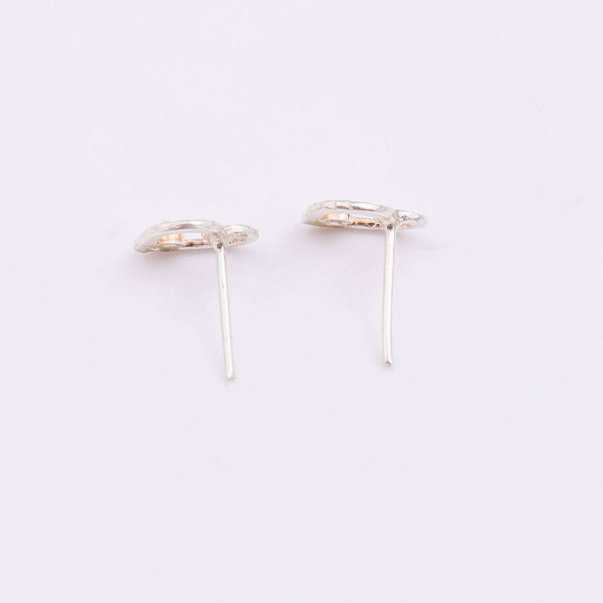 Silver heart pearl earrings on display with white background