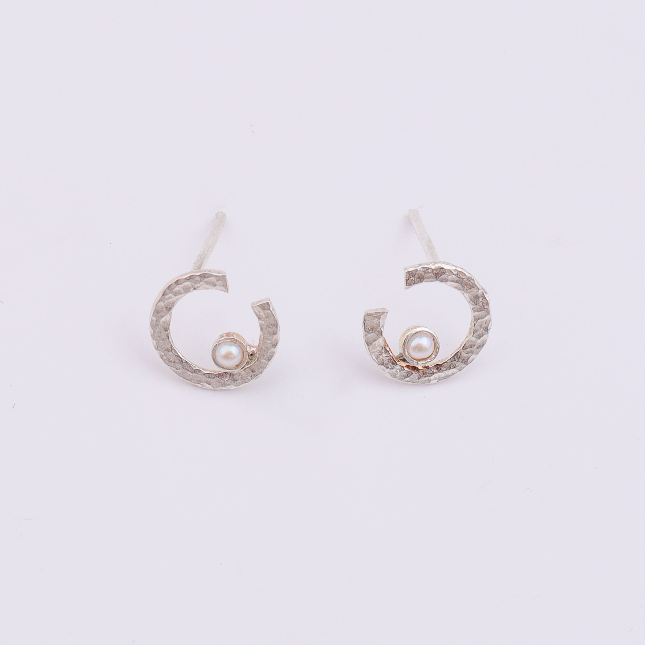 Back view of silver semi-circle pearl earrings