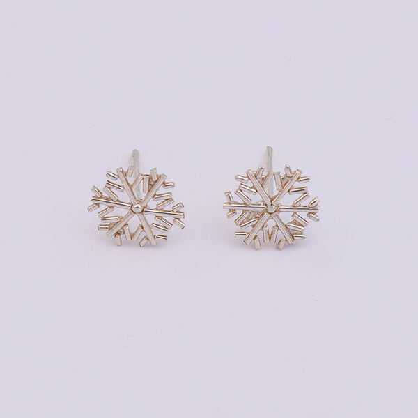 Silver snowflake earrings on display with white backdrop