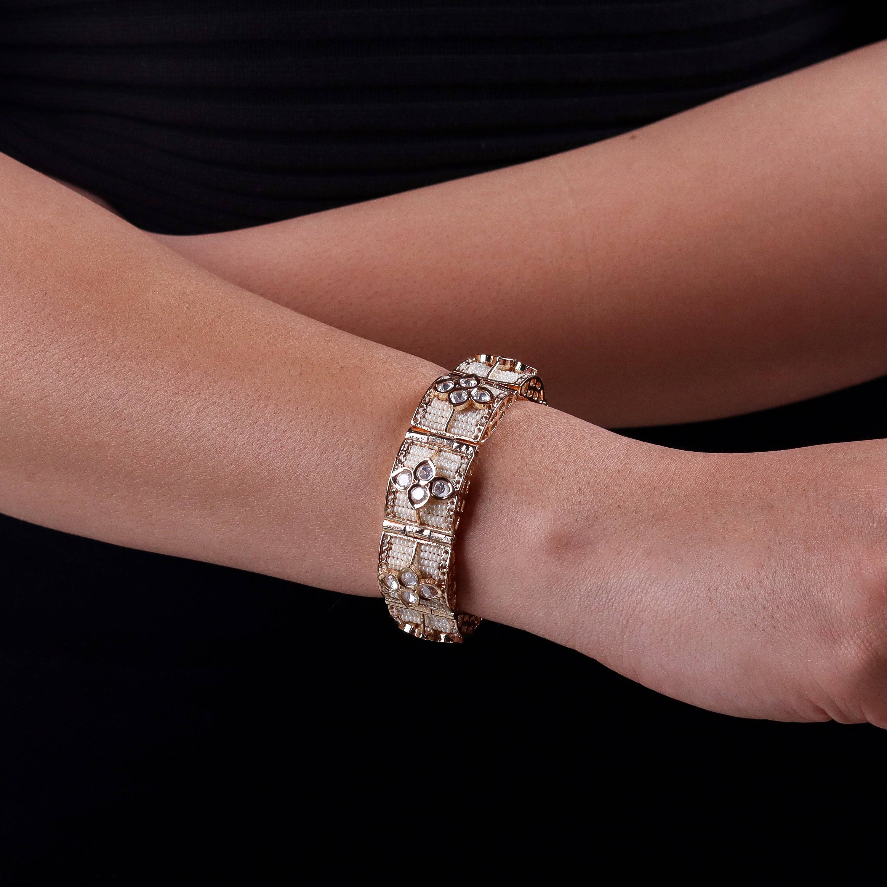 Model wearing a 22K gold-plated fashion bracelet for a sophisticated and contemporary jewelry look