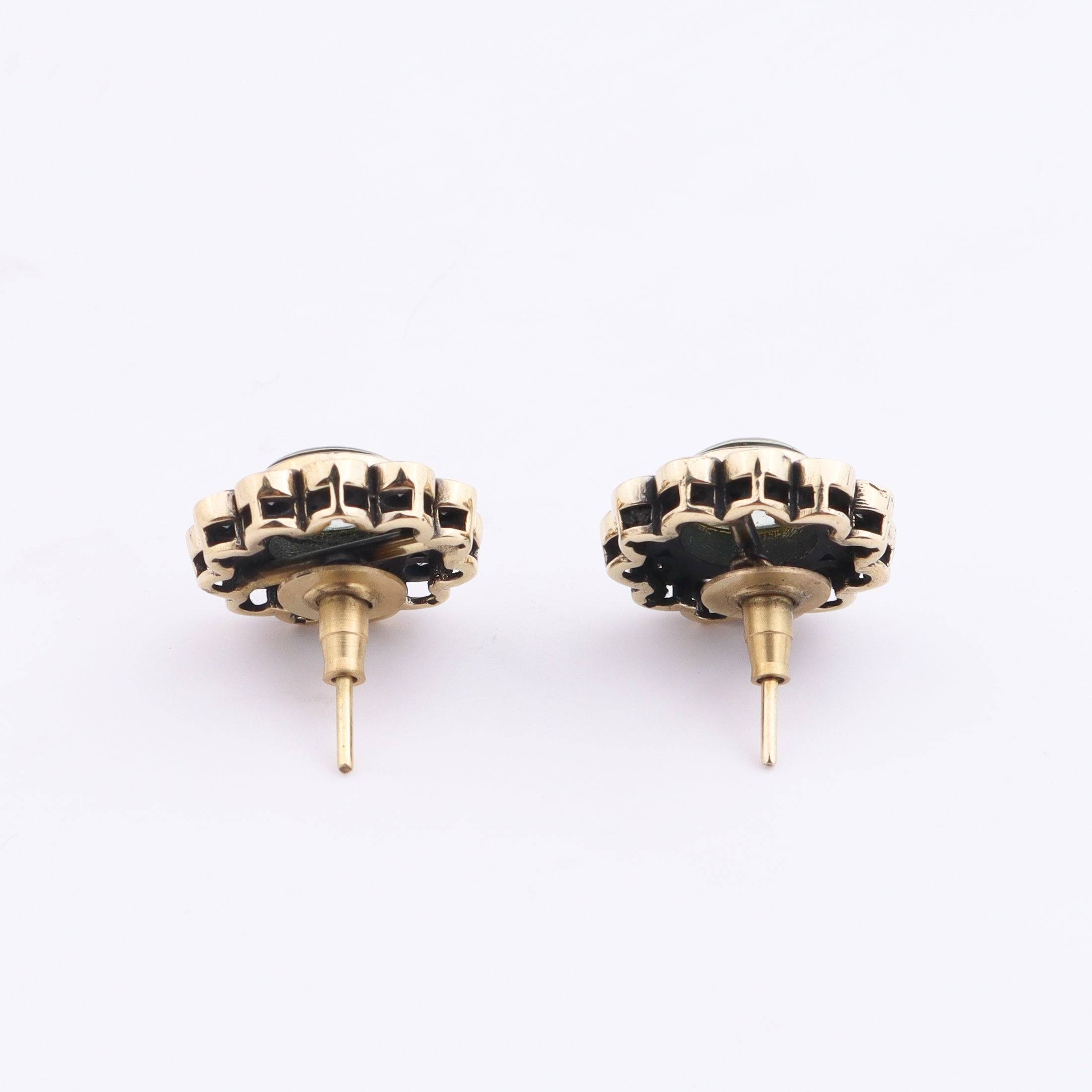 Angled view of Brass Fashion Earrings highlighting the unique silhouette, structure, and polished brass finish
