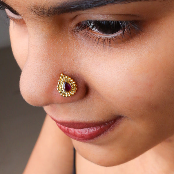 Gold plated pink stone nose pin on pierced nose