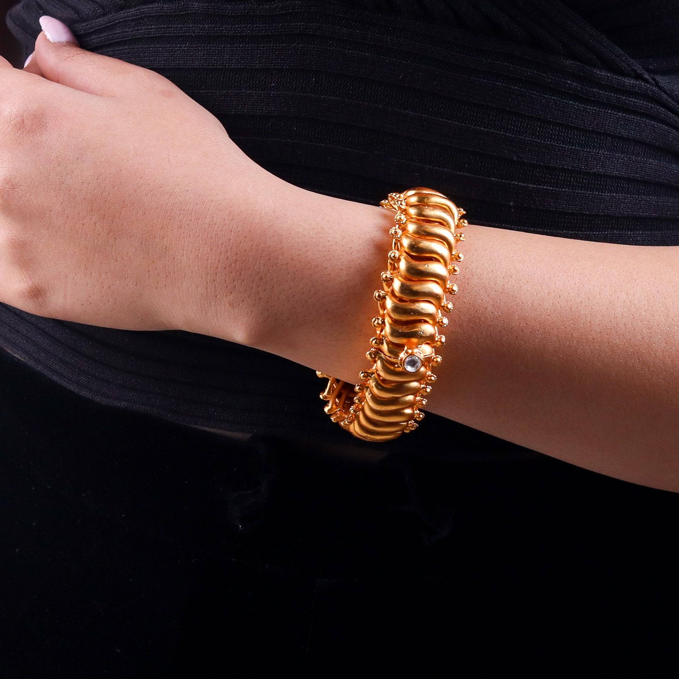 Model wearing a 22K gold-plated fashion bangle (single) for a sophisticated and elegant jewelry look