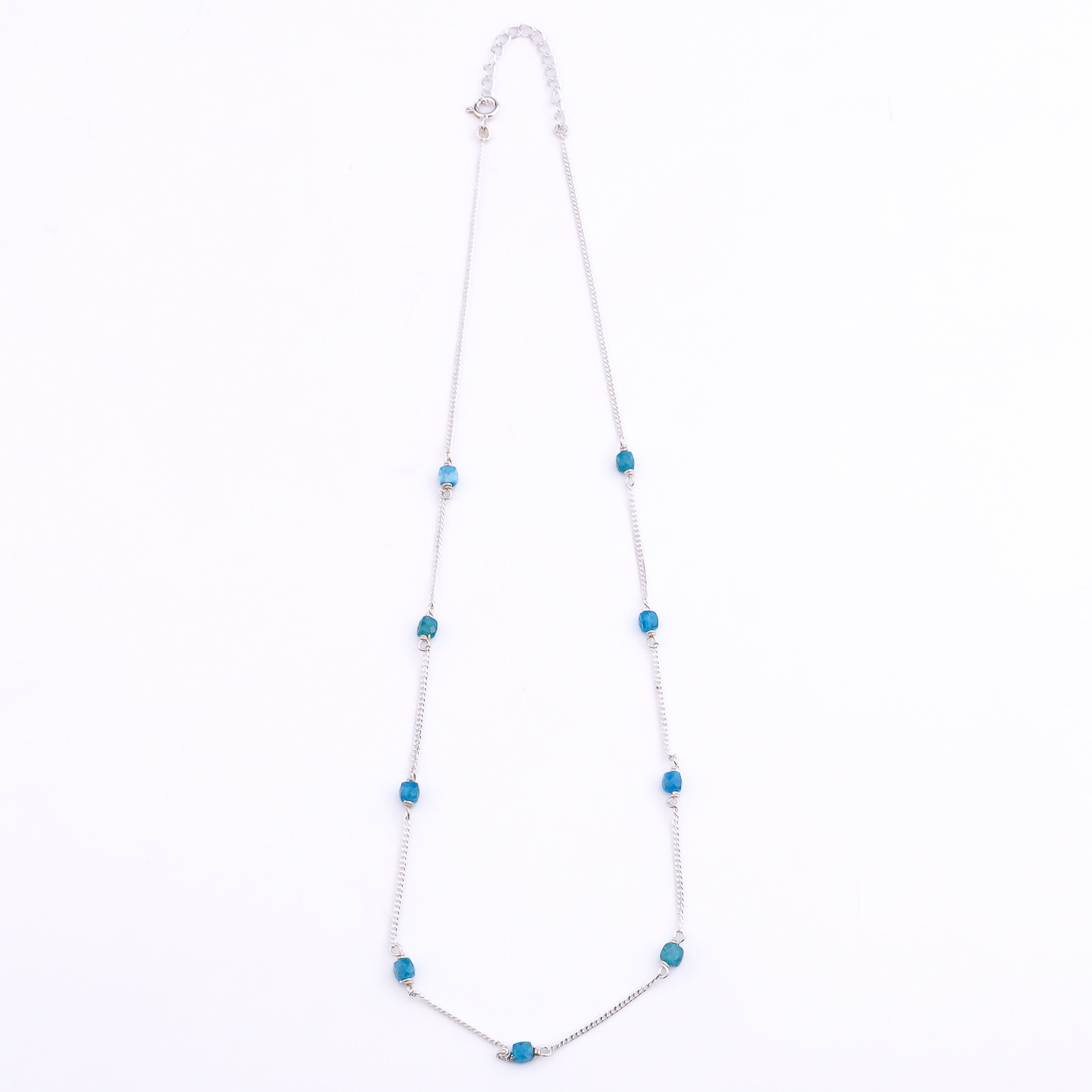Close-up of silver chain with blue apatite pendant