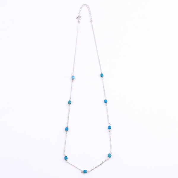 Close-up of silver chain with blue apatite pendant
