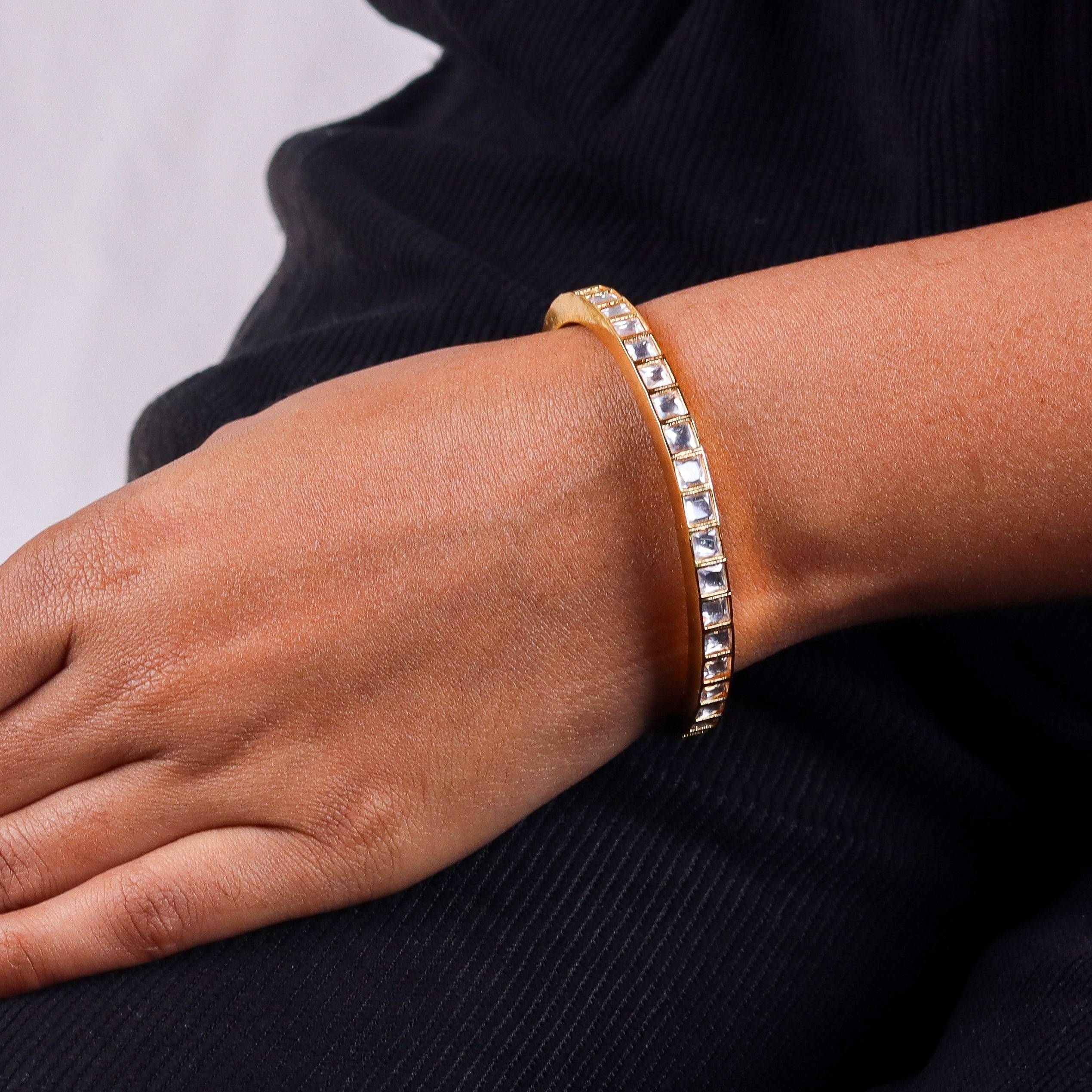 Model wearing a 22K gold-plated fashion bangle (single) for a sophisticated and elegant jewelry look