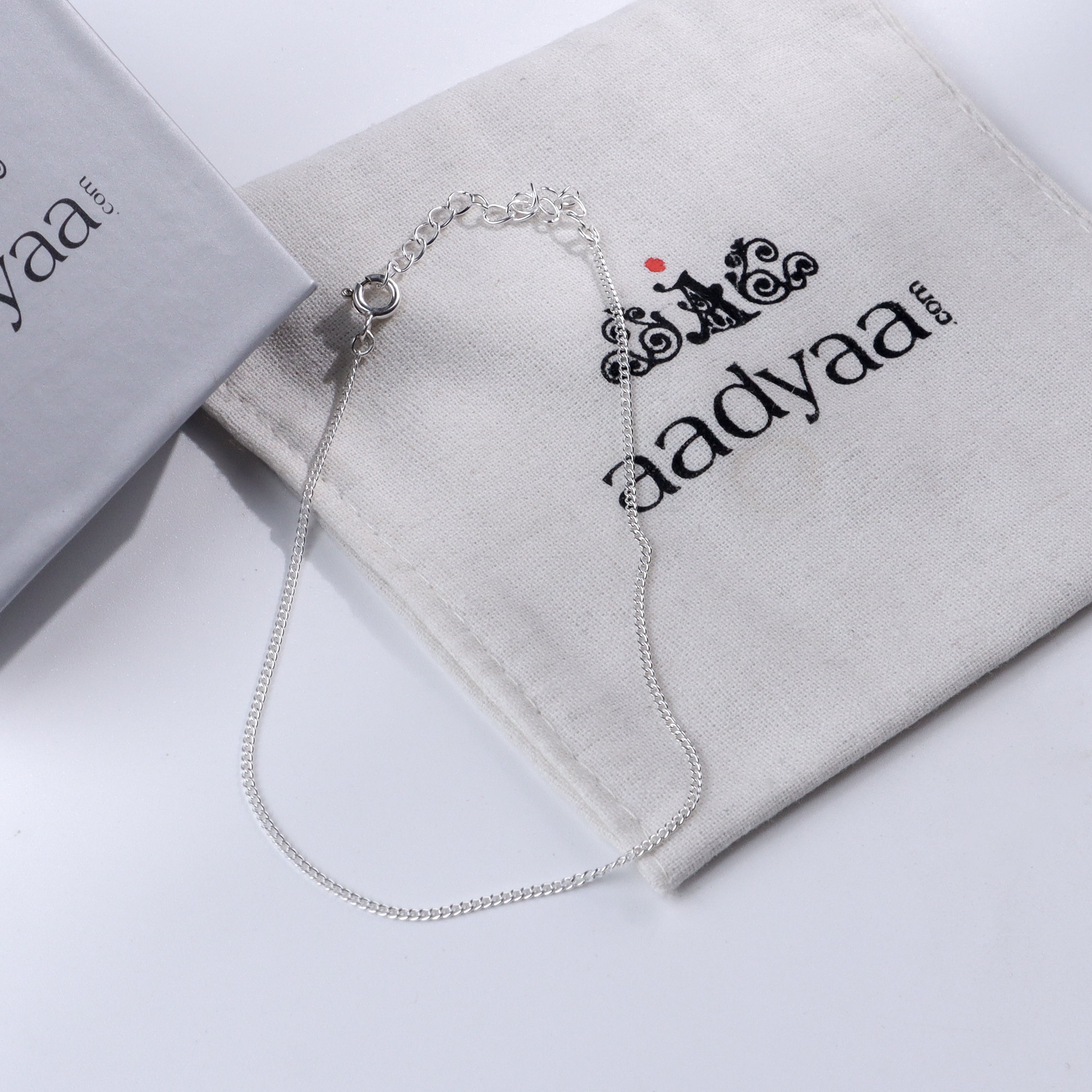 Plain silver chain anklet on Aadyaa jewelry pouch
