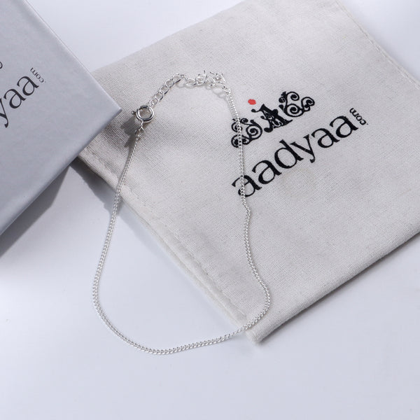 Plain silver chain anklet on Aadyaa jewelry pouch