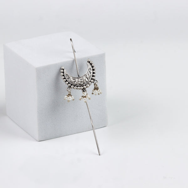 Silver earrings with intricate floral design and dangling pearl accents