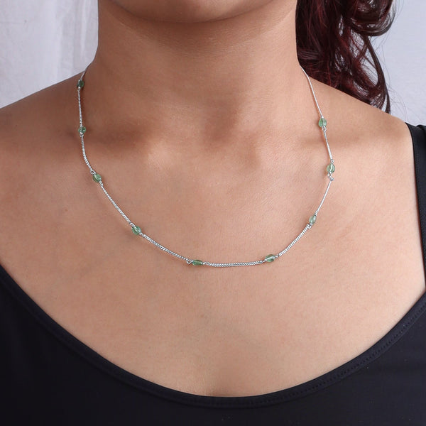 Neck shot of silver chain with green quartz beads