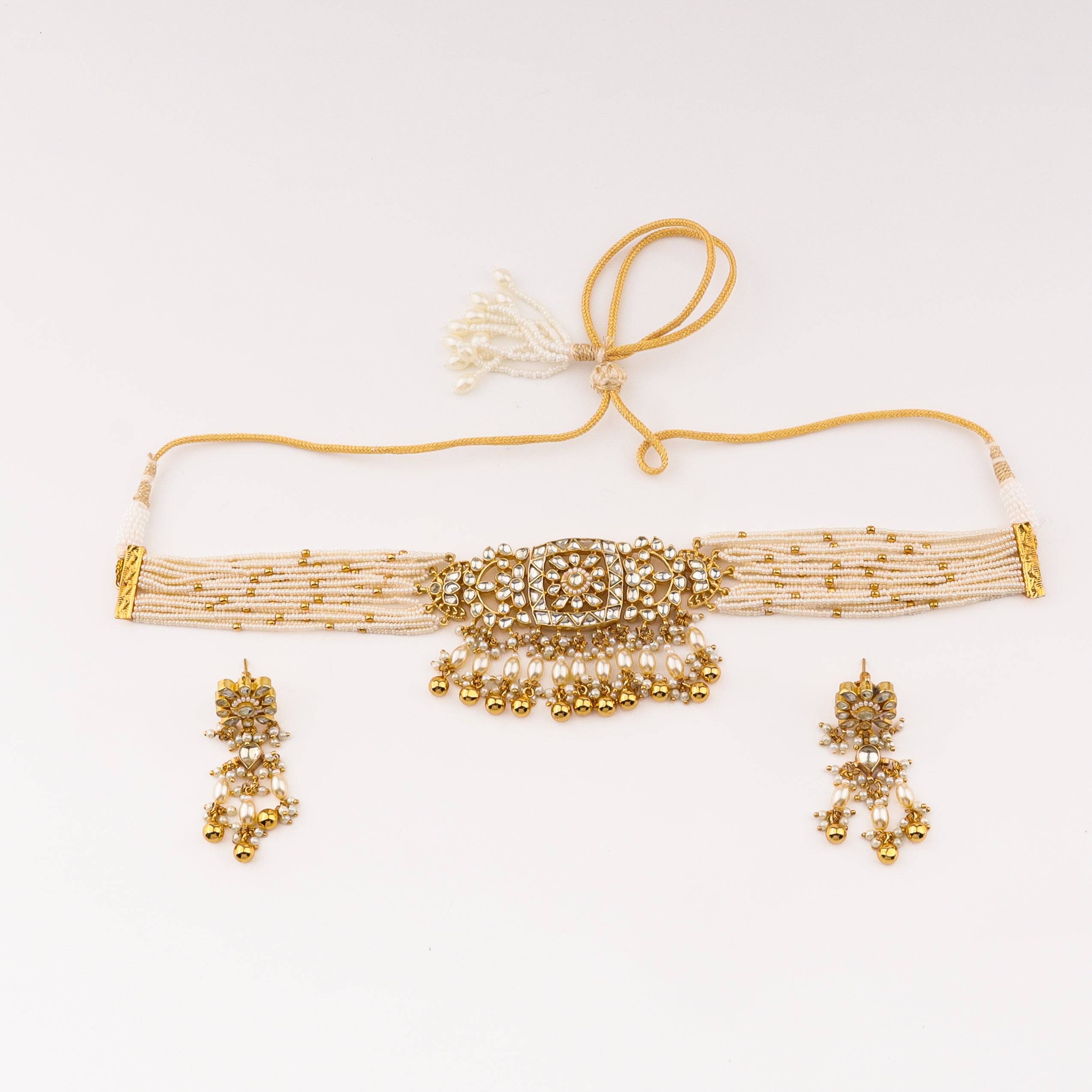 Detailed view of 22K gold-plated fashion set highlighting intricate motifs, textured detailing, and premium 22K gold-plated finish