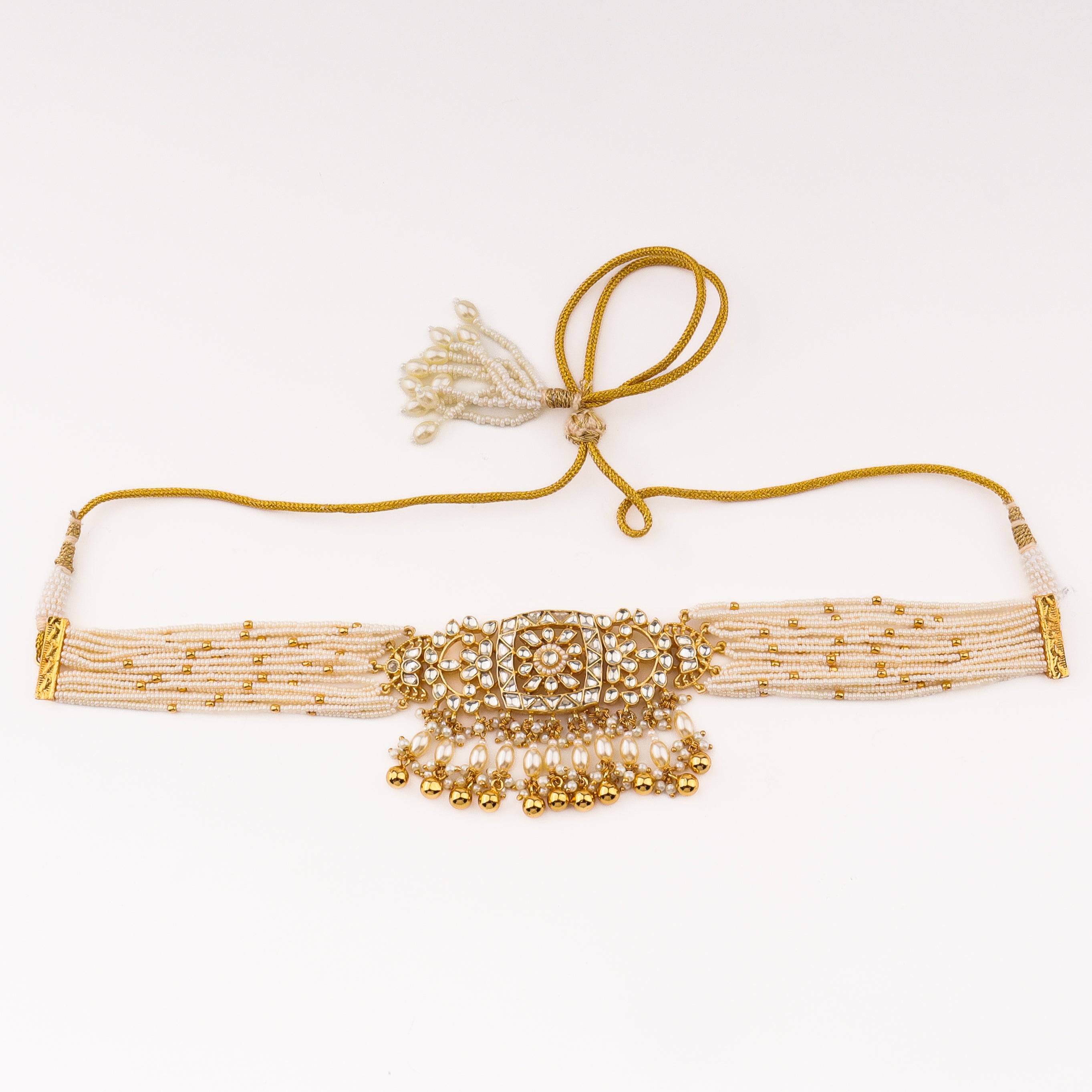 Detailed view of a 22K gold-plated fashion set highlighting intricate motifs, textured detailing, and a premium 22K gold-plated finish