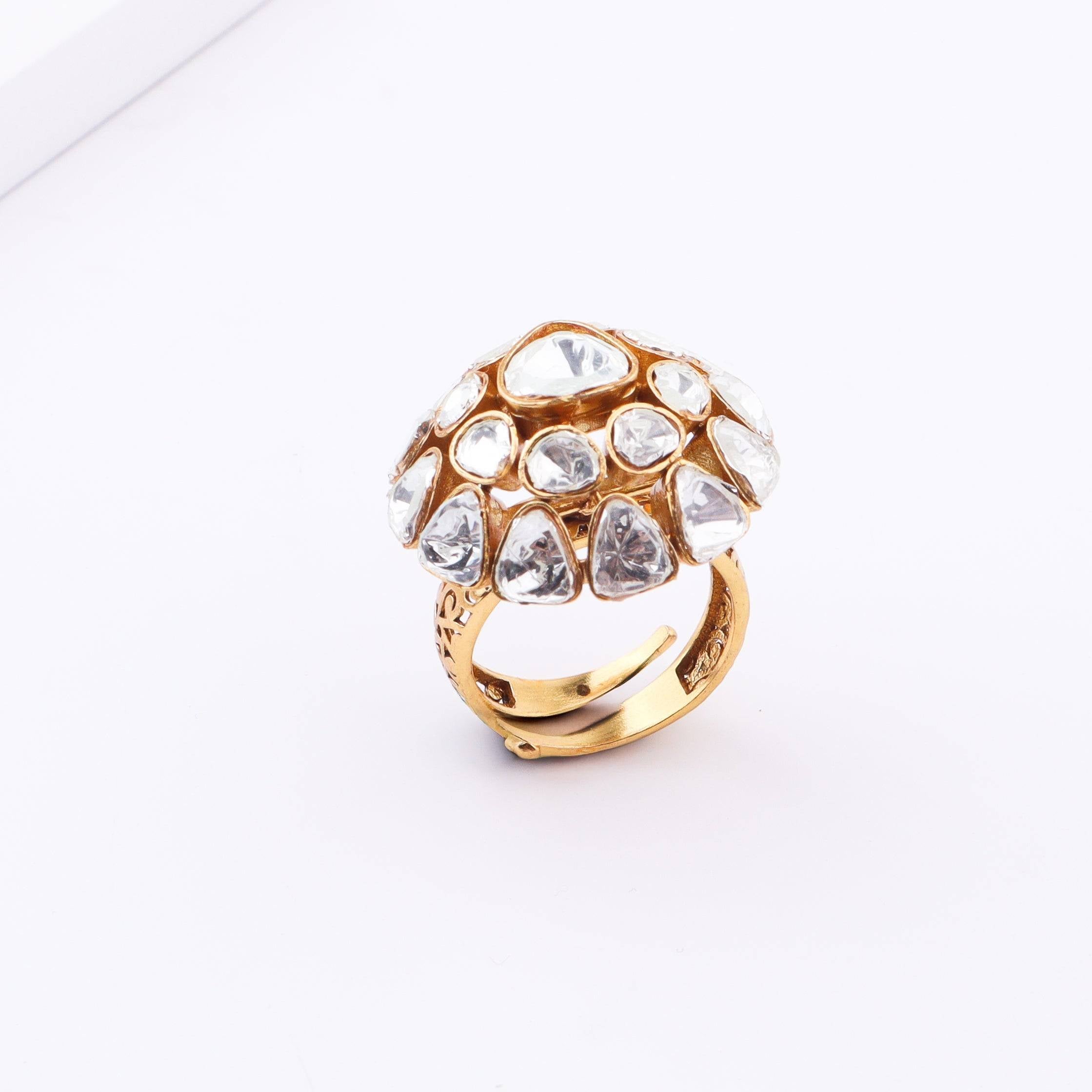 Flat-lay of a brass fashion ring with complementary jewellery and accessories for a chic styling setup
