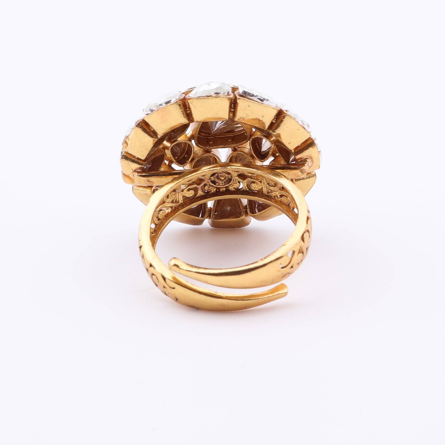 Angled view of a brass fashion ring highlighting its distinctive shape, structure, and polished brass finish