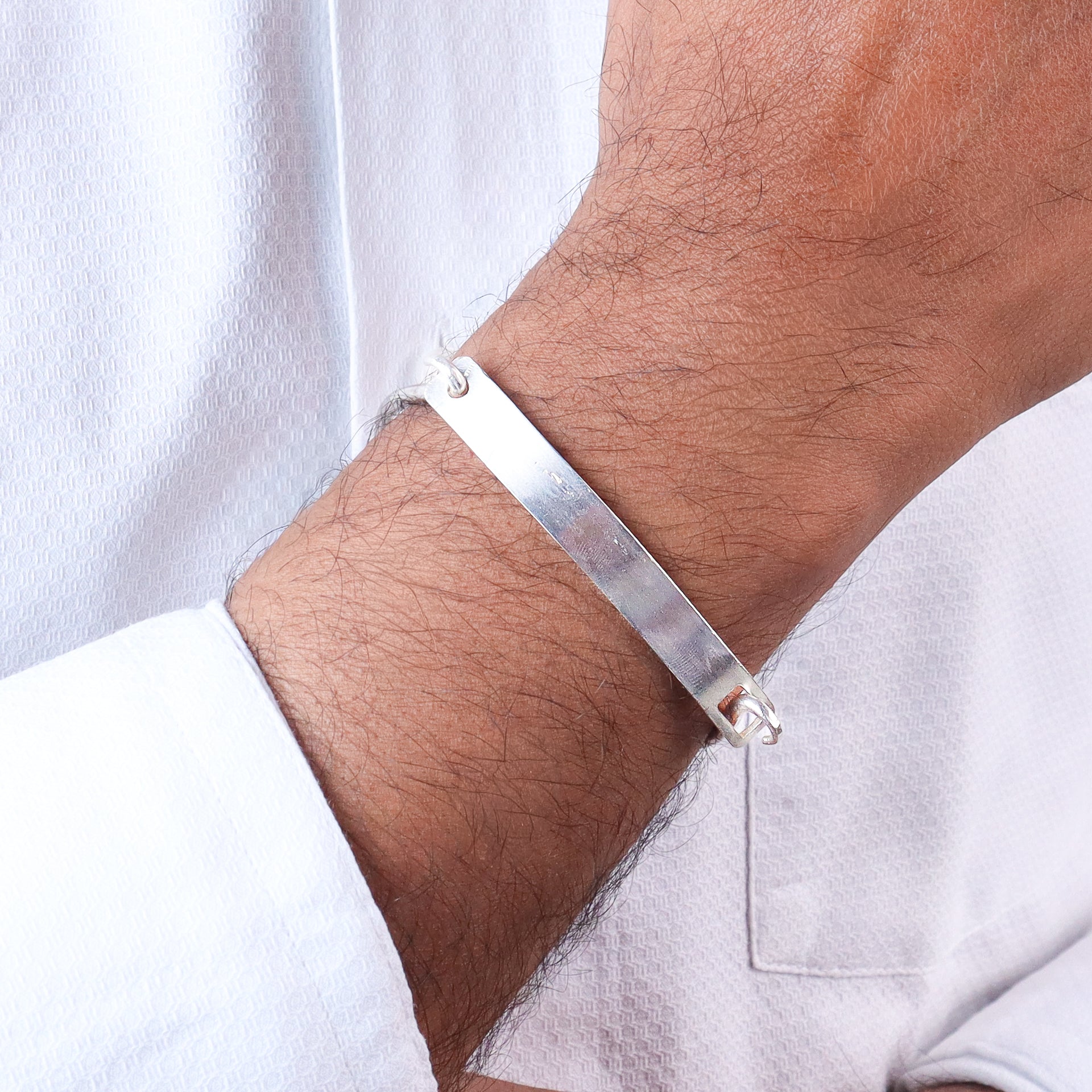 Close-up of silver bracelet on model's wrist