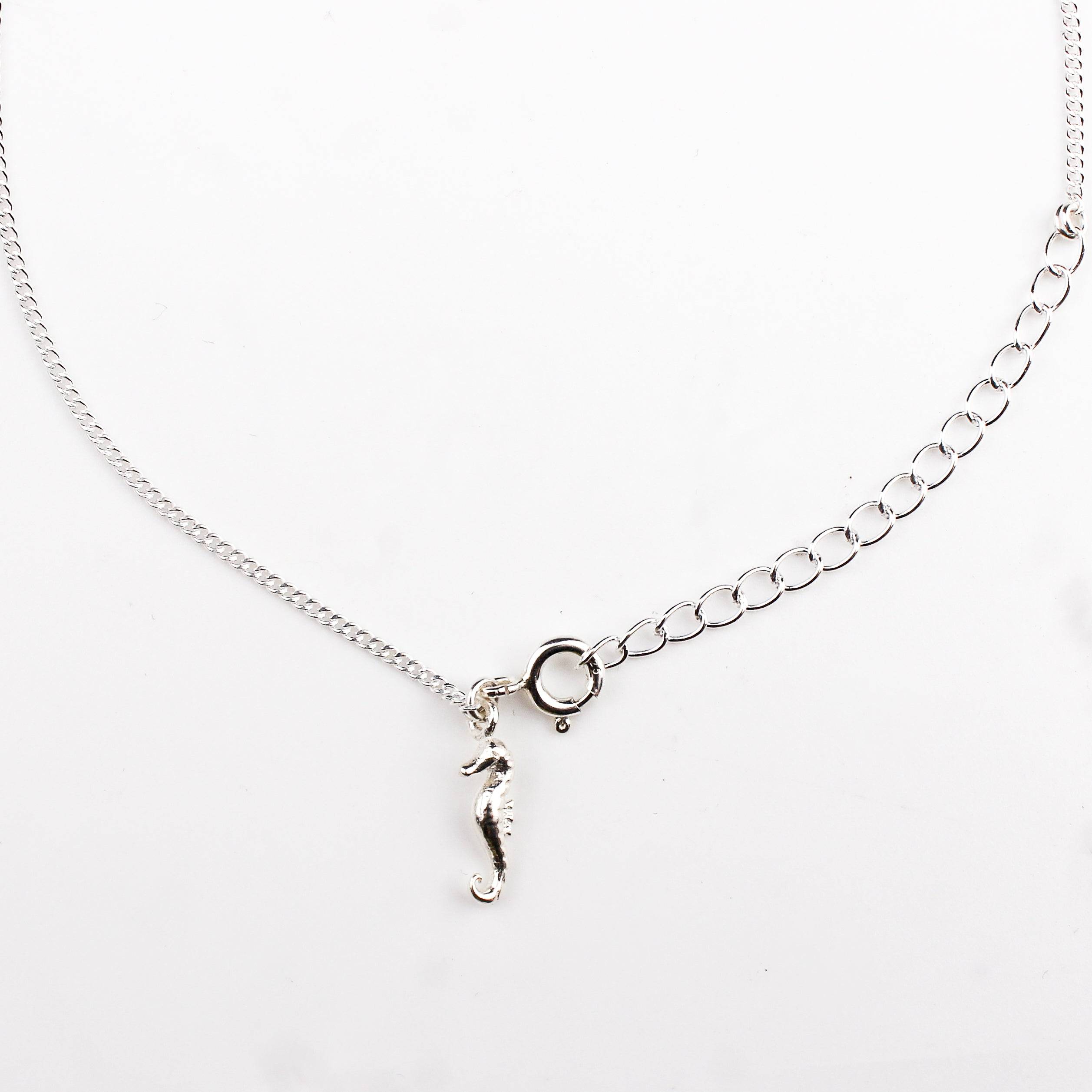 Close-up of silver seahorse charm anklet detailing