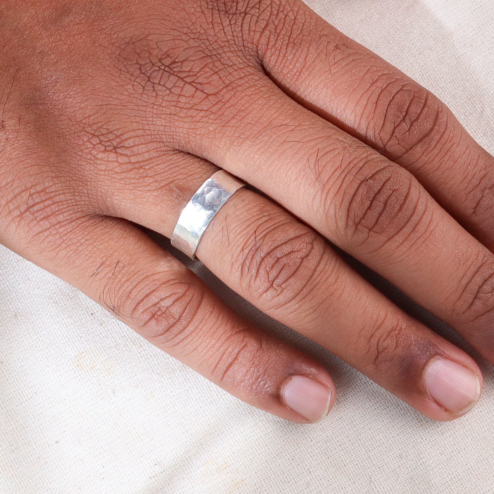 Unisex hammered silver ring on finger