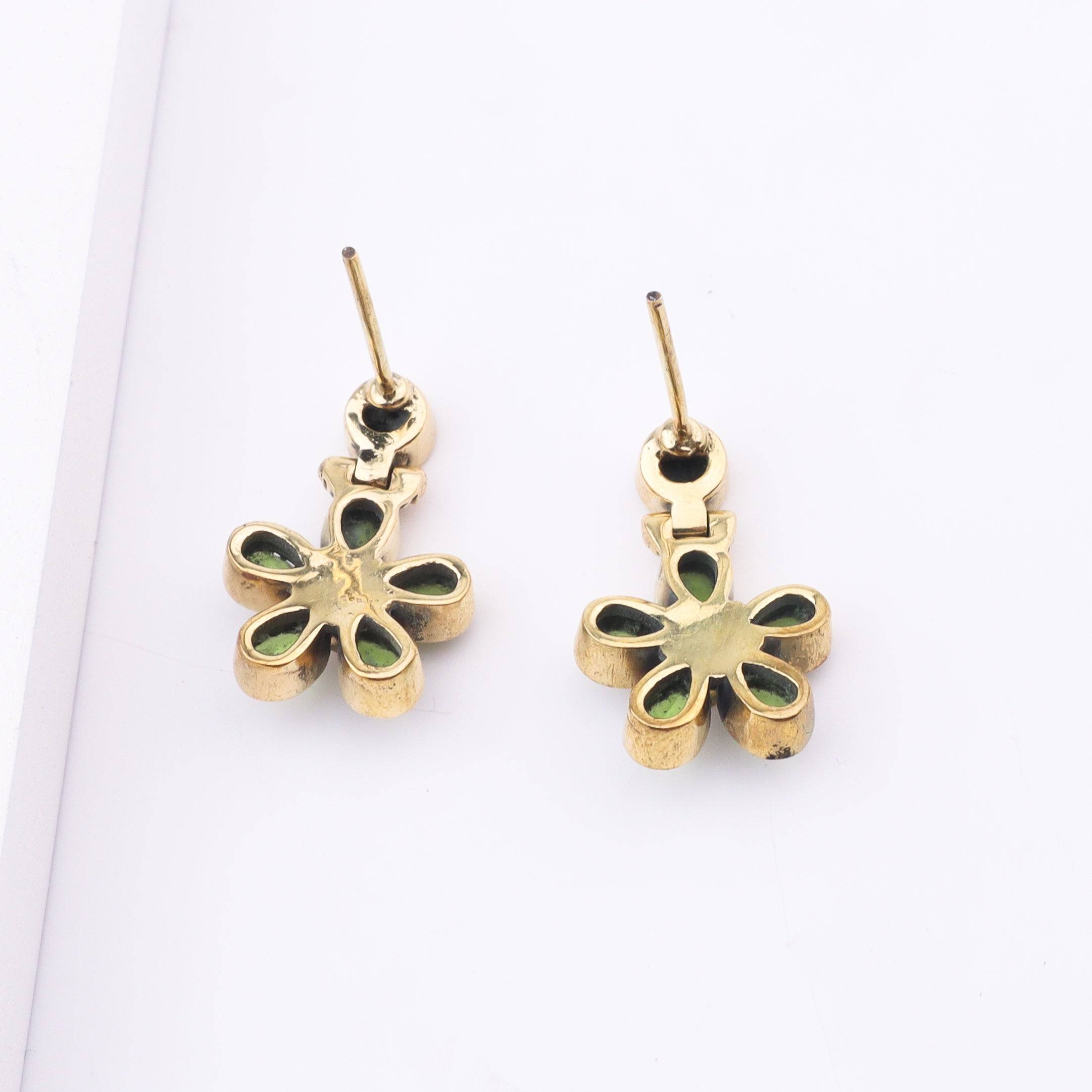 Angled view of Brass Fashion Earrings highlighting the unique silhouette, structure, and polished brass finish