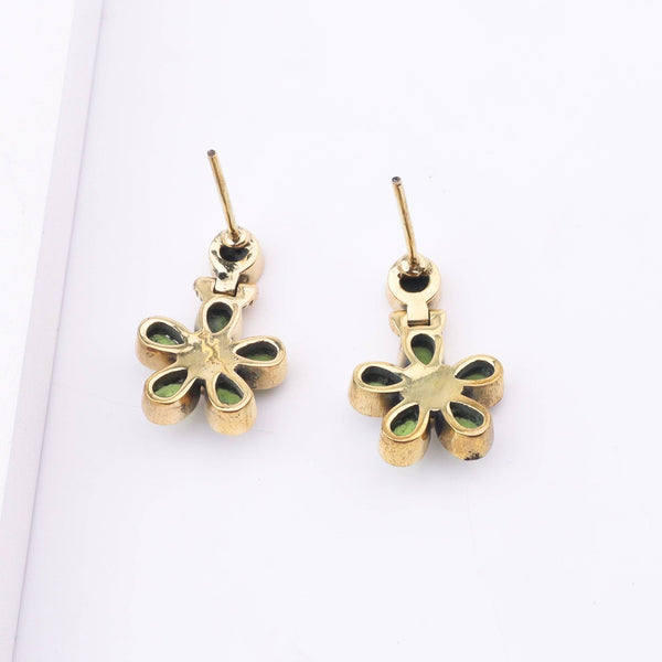 Angled view of Brass Fashion Earrings highlighting the unique silhouette, structure, and polished brass finish