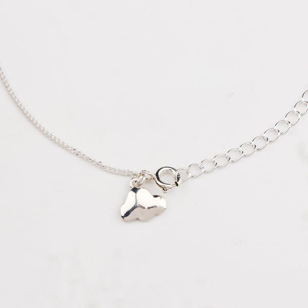 Close-up of silver cloud charm anklet detailing