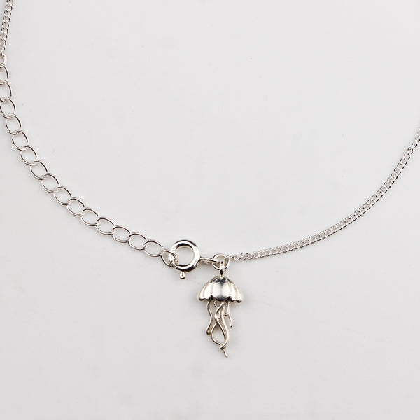 Close-up of silver jellyfish charm anklet detailing