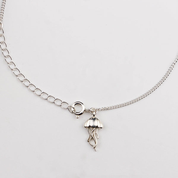 Close-up of silver jellyfish charm anklet detailing