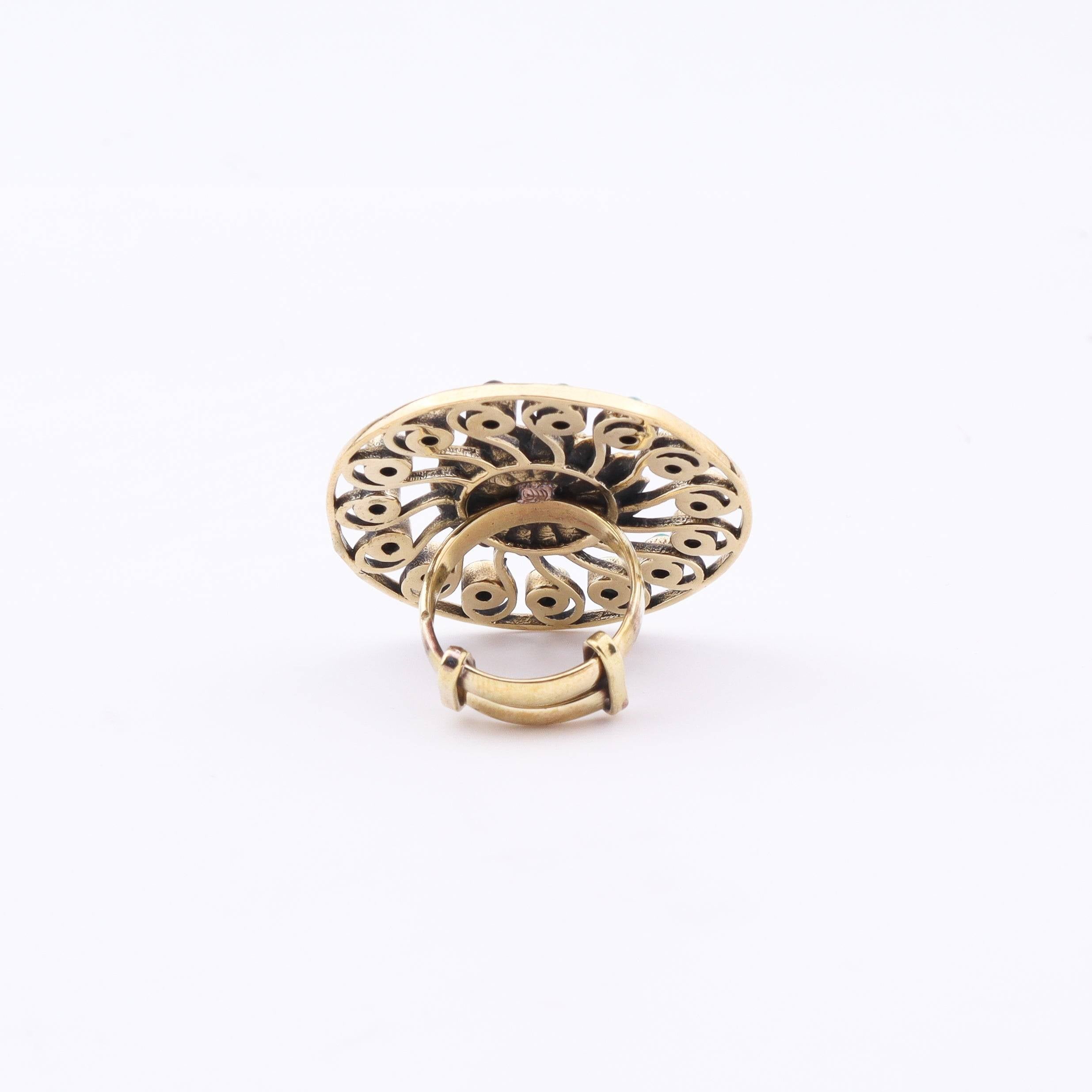 Angled view of a brass fashion ring highlighting its distinctive shape, structure, and polished brass finish