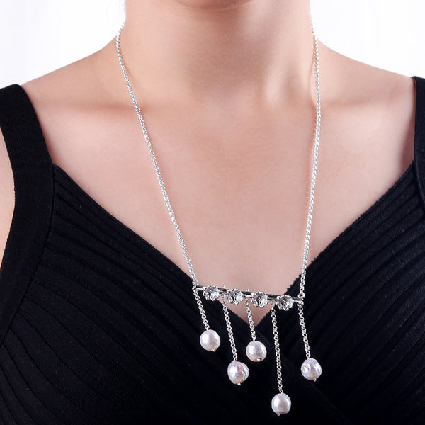 Silver flower pearl necklace worn on a model