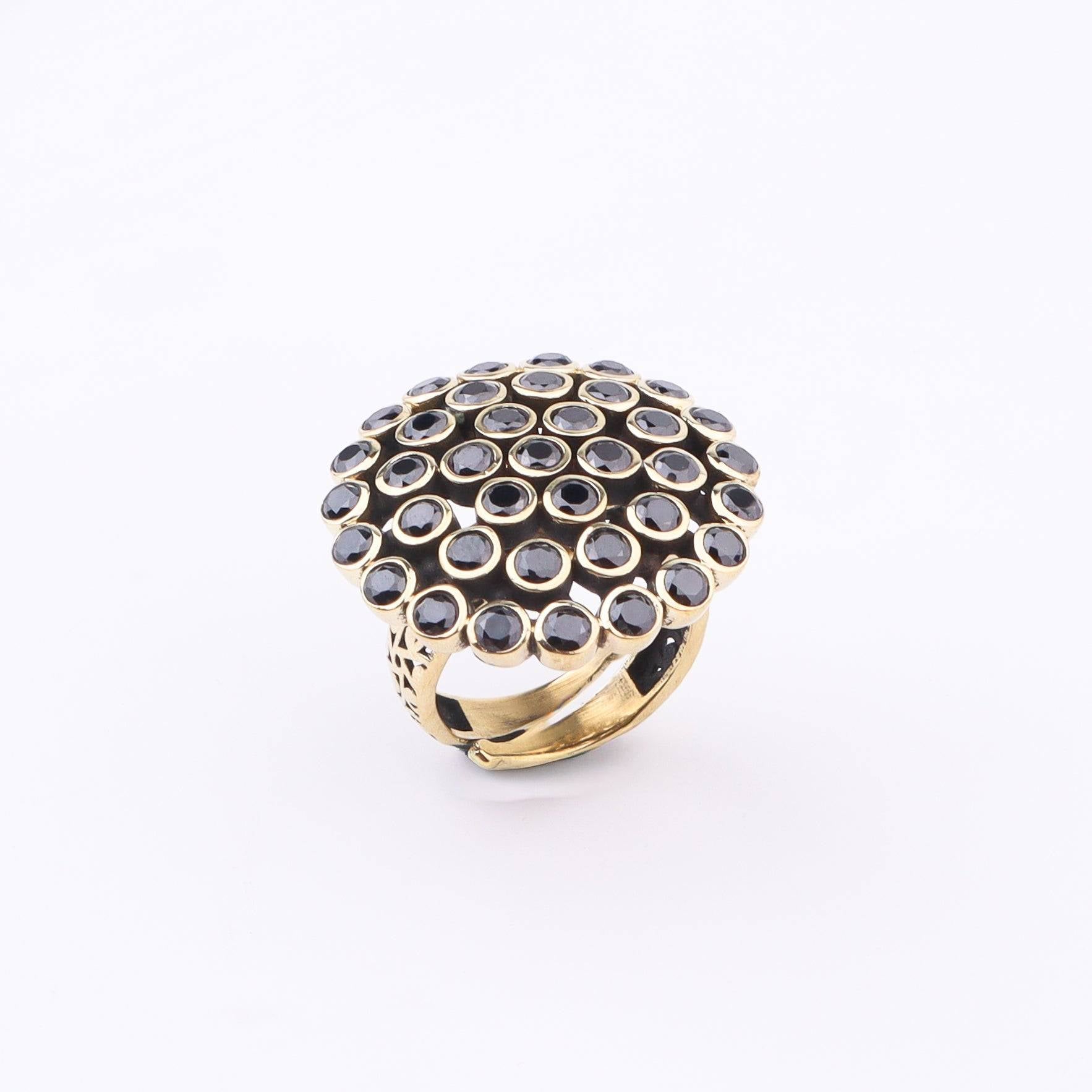 Flat-lay of a brass fashion ring with complementary jewellery and accessories for a chic styling setup