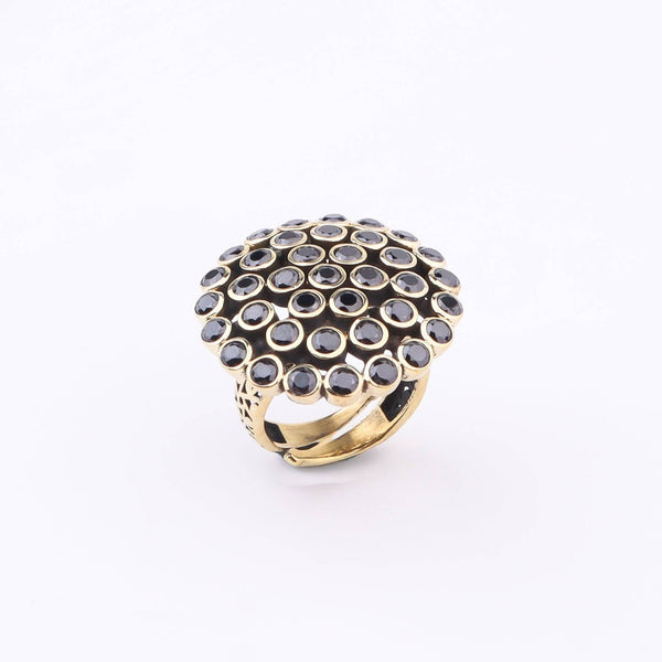 Flat-lay of a brass fashion ring with complementary jewellery and accessories for a chic styling setup