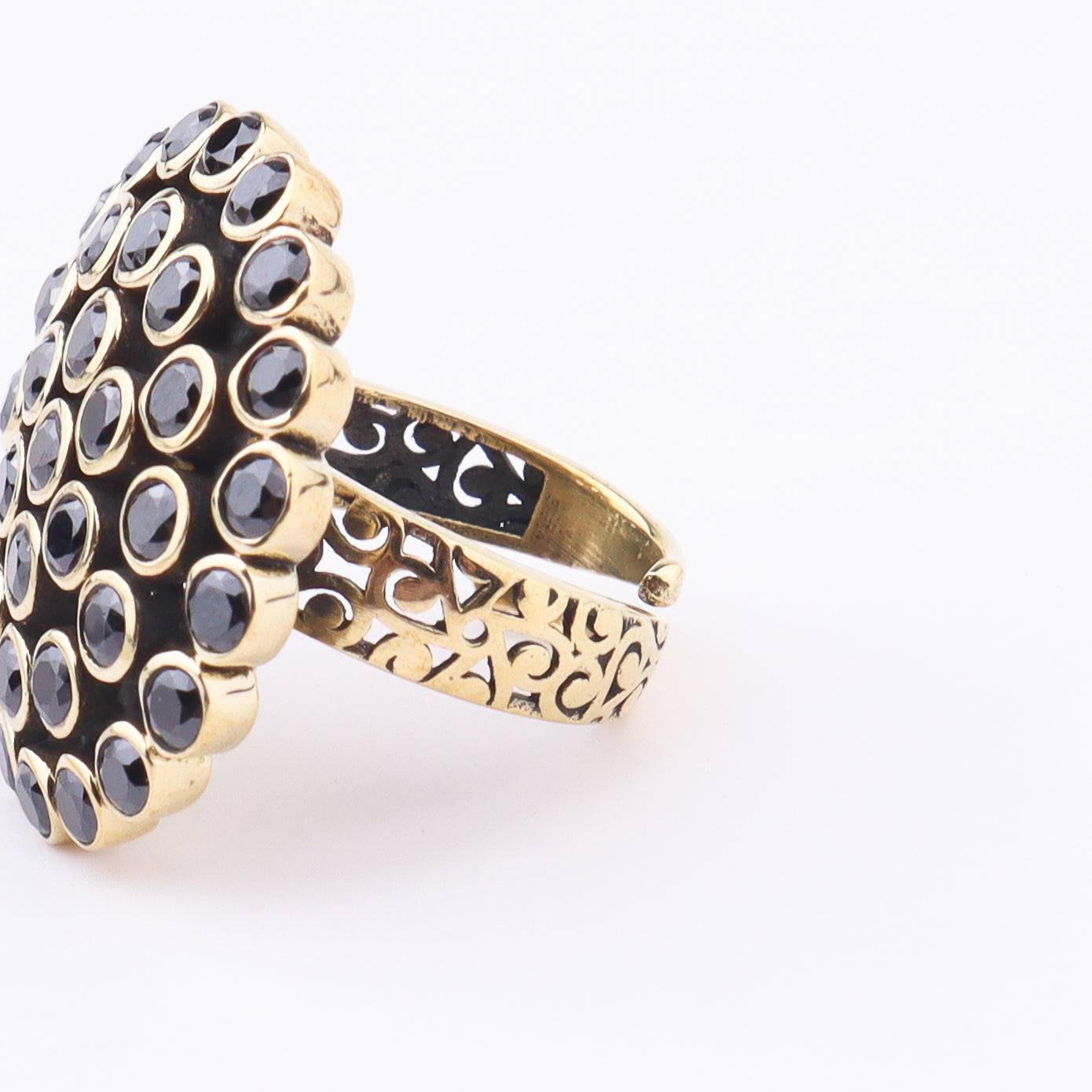 Close-up of a brass fashion ring showcasing intricate detailing, unique design, and fine craftsmanship
