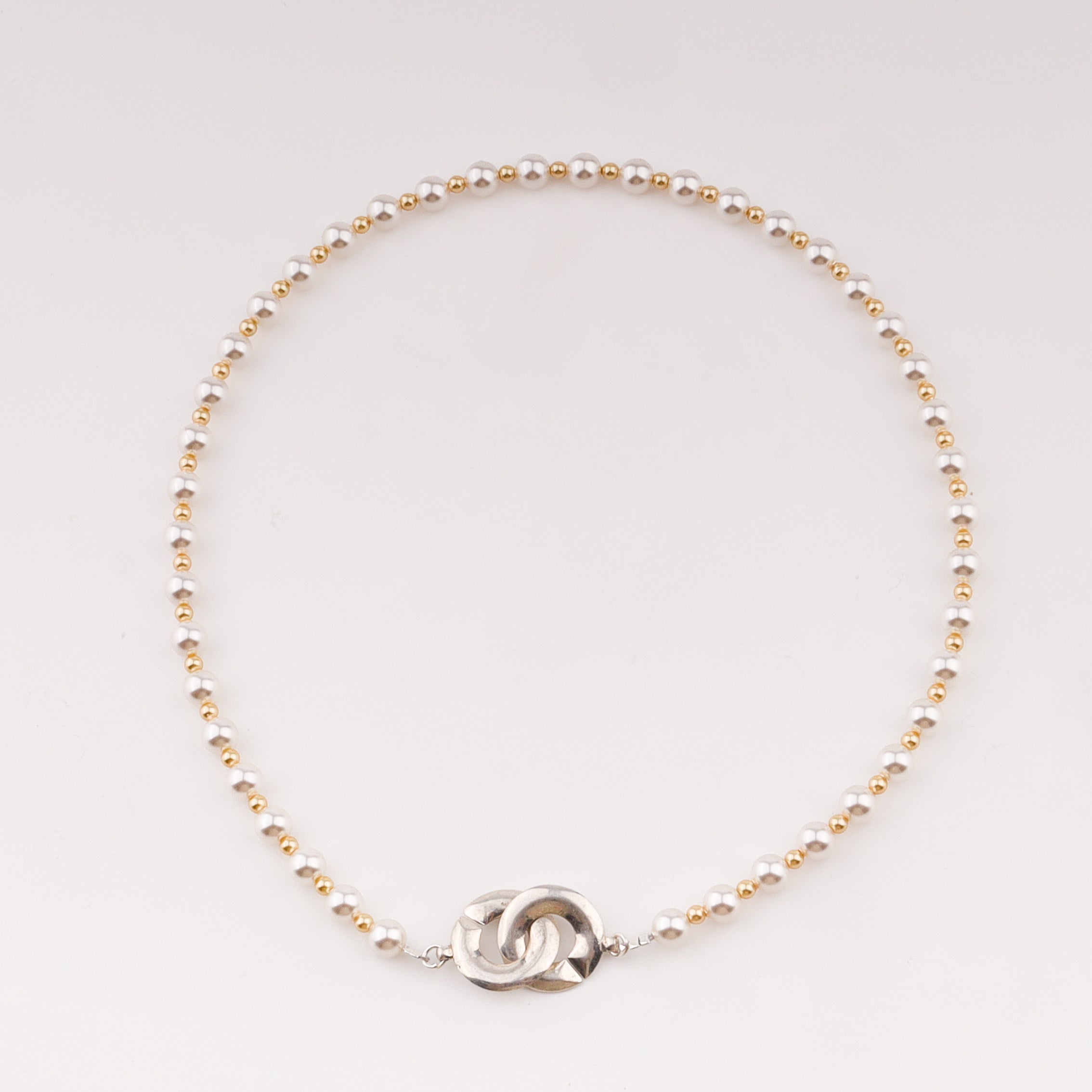 Infinity lock necklace with white and gold pearls