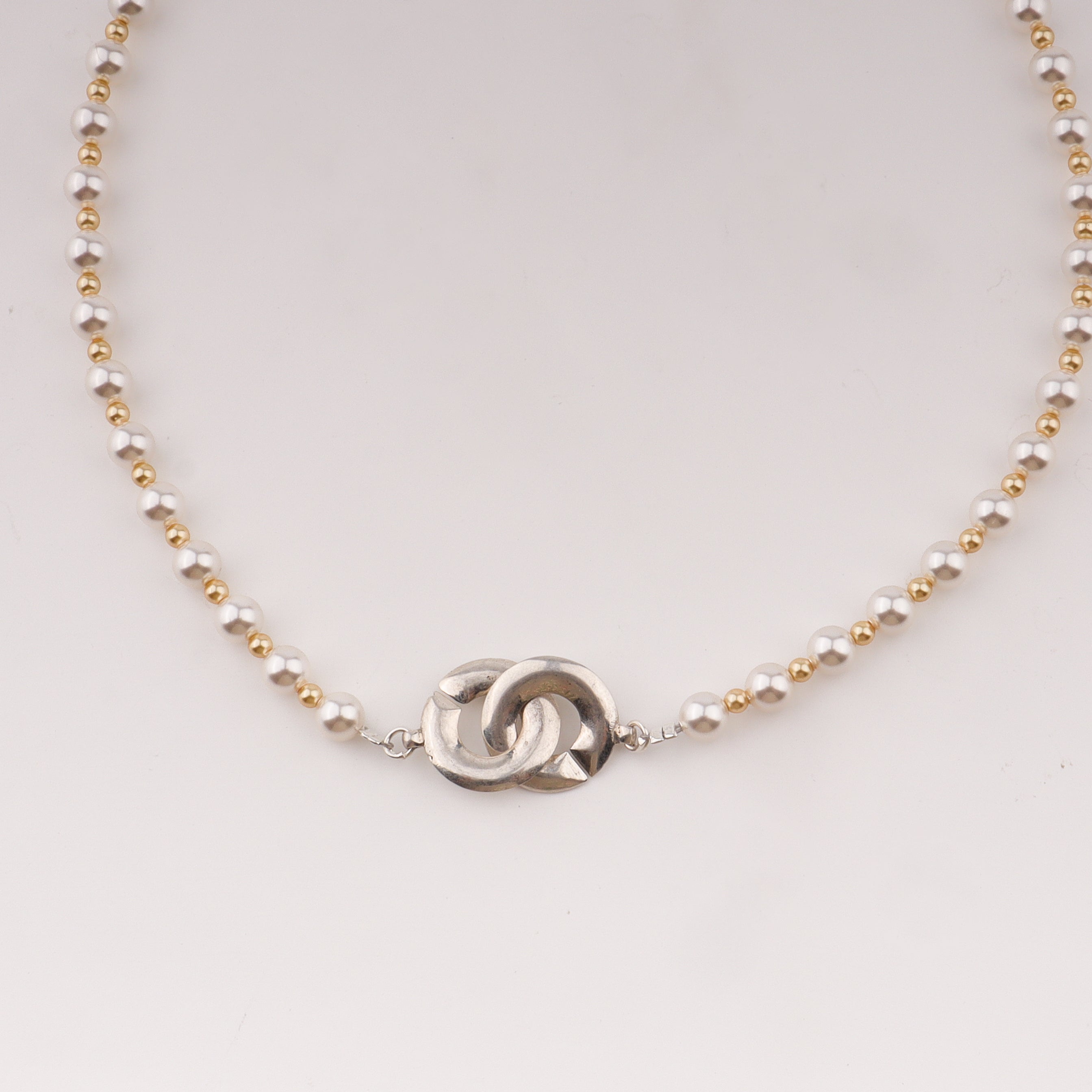Infinity lock necklace with white and gold pearls