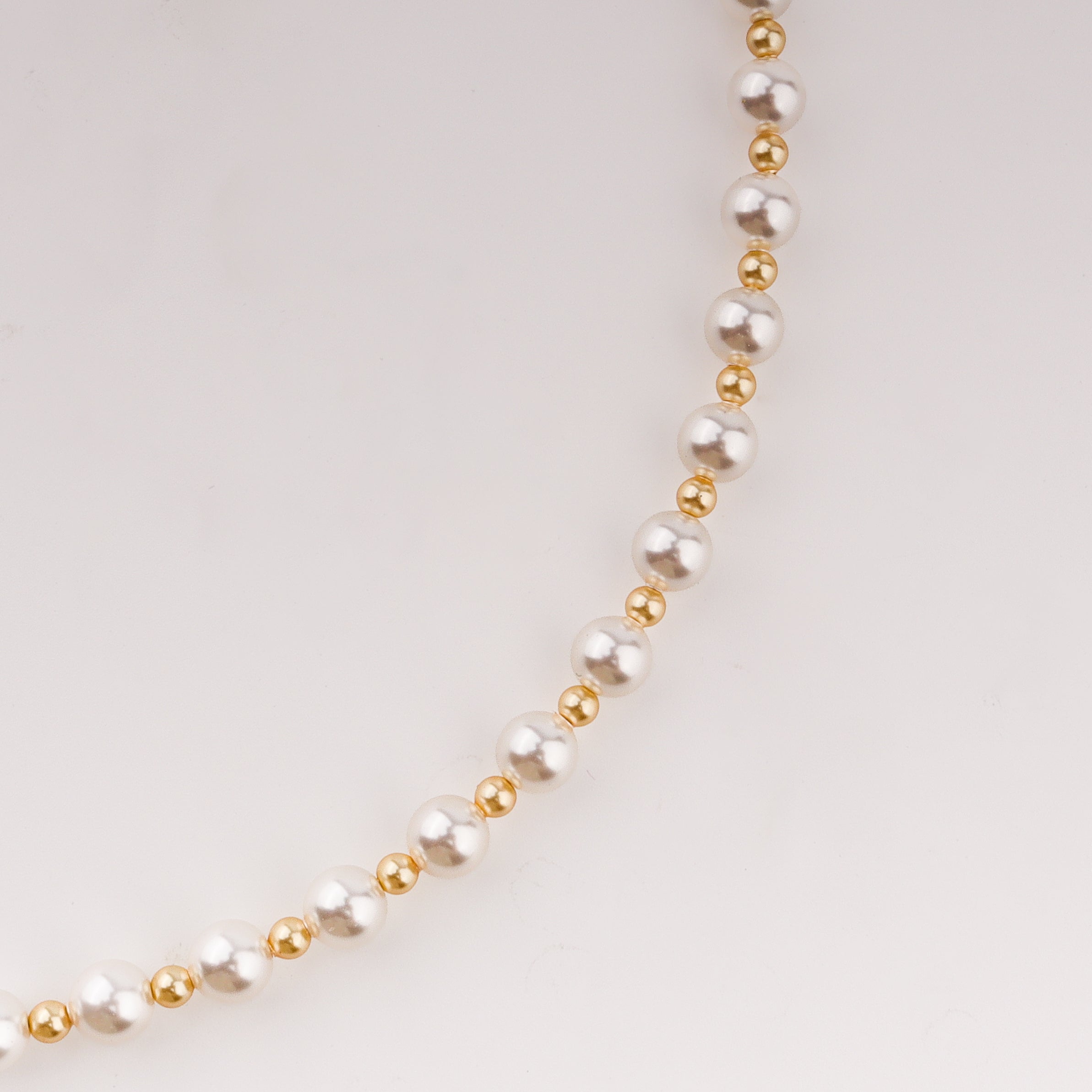 Infinity lock necklace with white and gold pearls