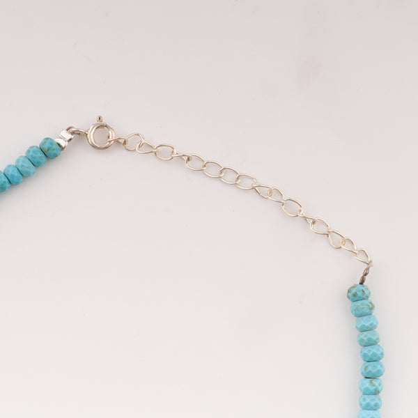Turquoise beaded anklet on ankle with adjustable chain