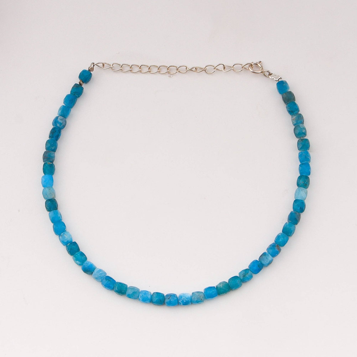 Blue apatite beaded anklet on white background with clasp detail