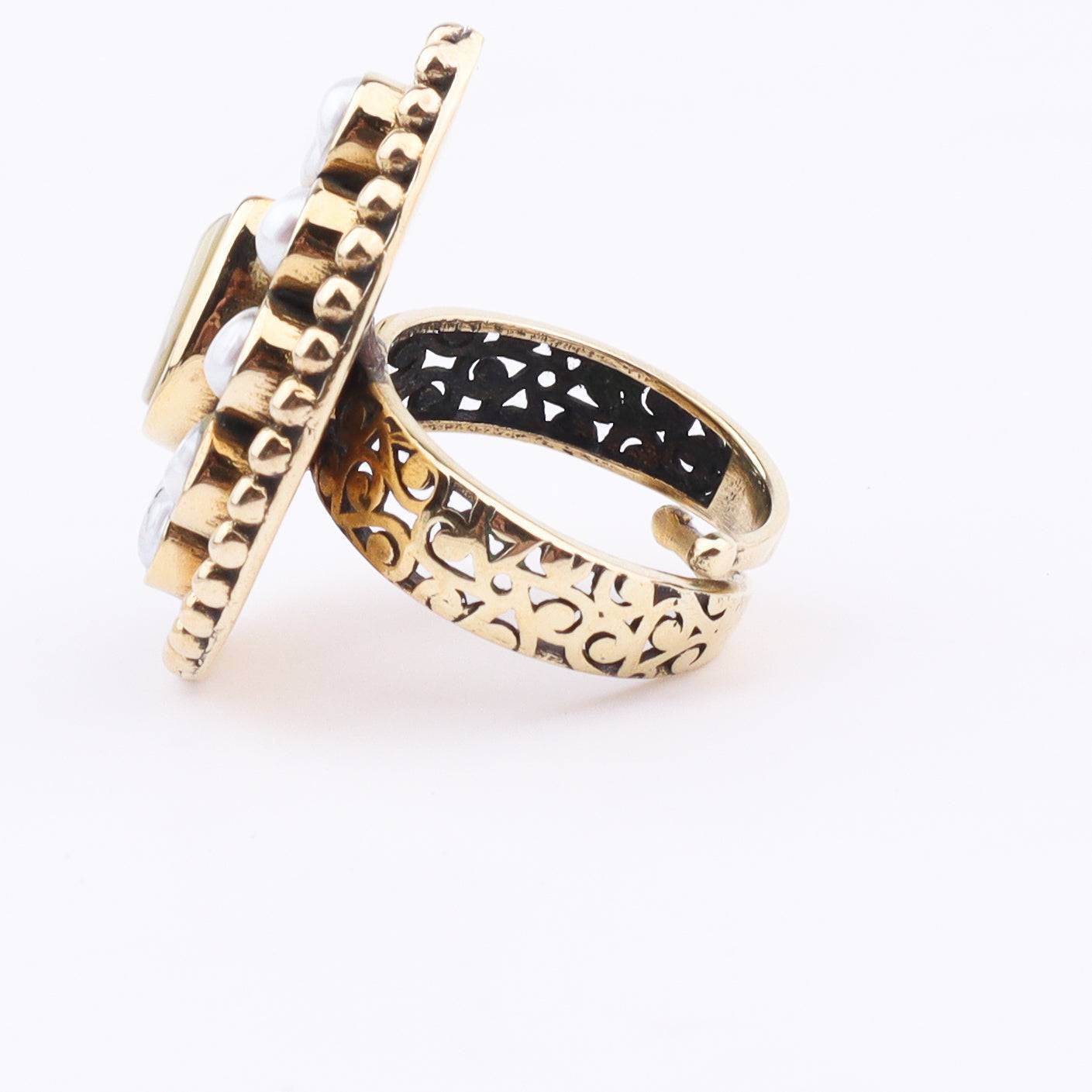 Flat-lay of a brass fashion ring with complementary jewellery and accessories for a chic styling setup